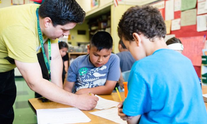 Teacher helping students