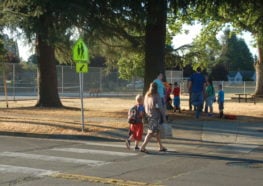 Student and guardian crossing at designated crosswalk