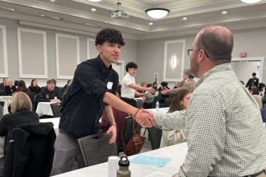 Student shaking hands with an interviewer