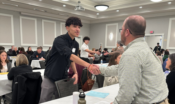Student shaking hands with an interviewer