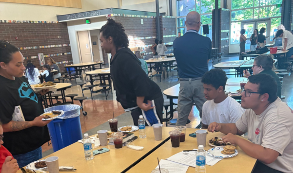 Families eating dinner at a cafeteria table