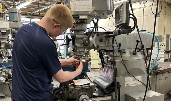 Student working on a vertical mill machine