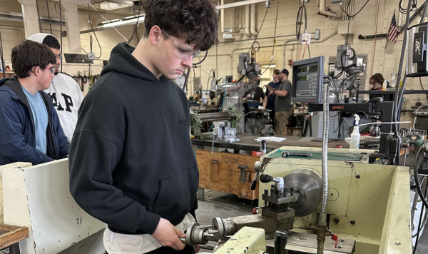 Student working on a lathe maching