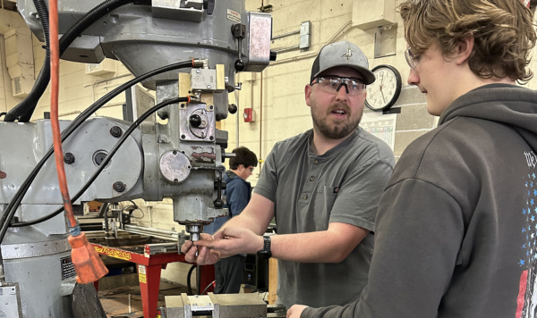 Teacher and a student at a vertical mill