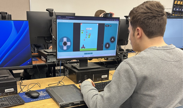 Student testing their coding on a computer