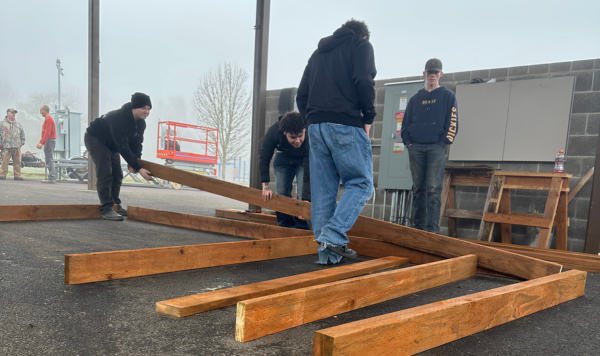 Students moving construction wood
