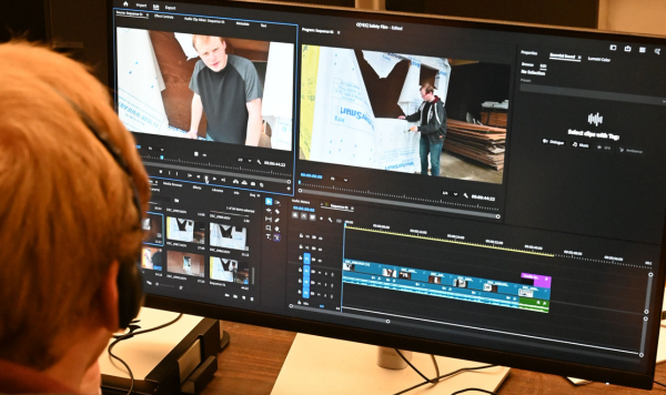 Student editing video on a computer