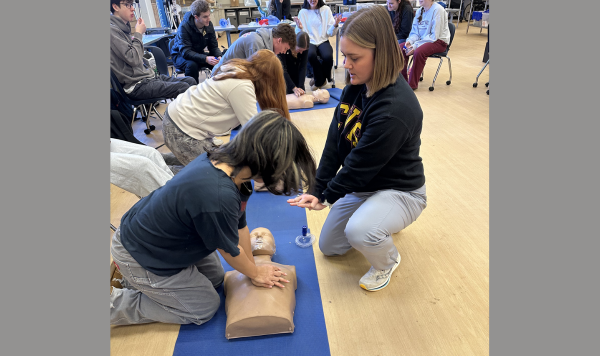 Teacher showing a student CPR technique