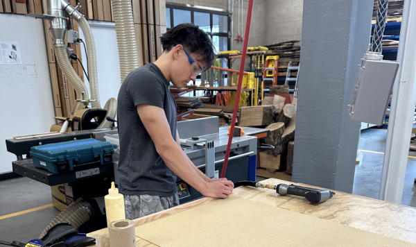 Student gluing boards together