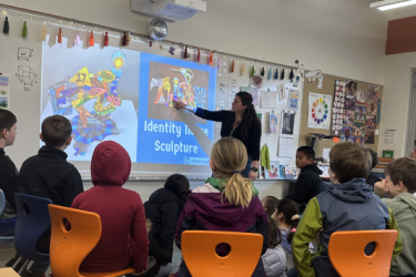Teacher in classroom in front of students