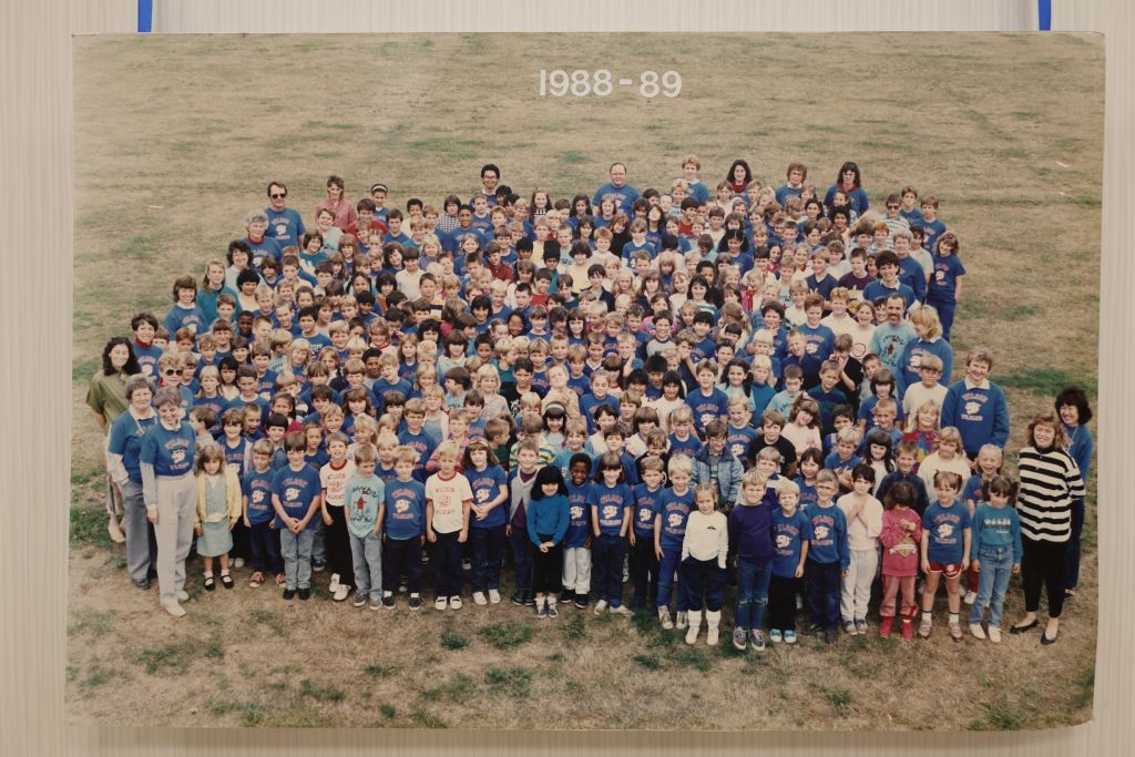 Students and staff standing in a field
