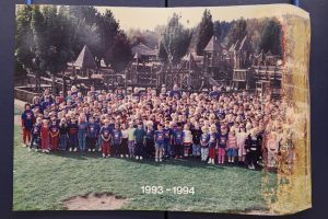 Students and staff in front of a playground