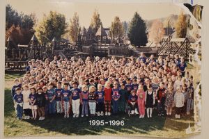 Students and staff in front of a playground