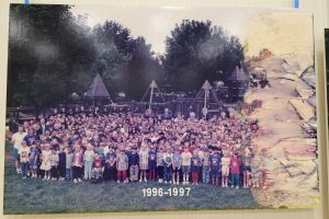 Students and staff in front of a playground