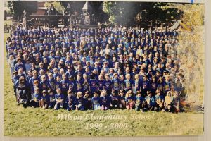 Students and staff in front of a playground