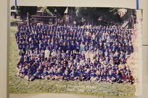 Students and staff in front of a playground