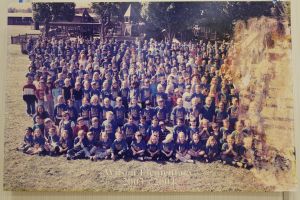 Students and staff in front of a playground