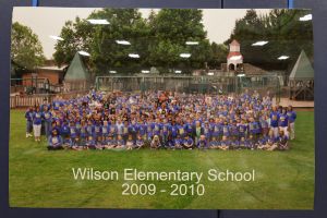 Students and staff in front of a playground