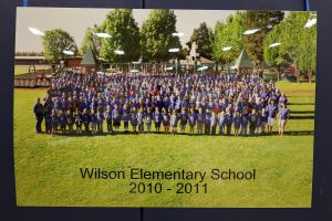 Students and staff in front of a playground