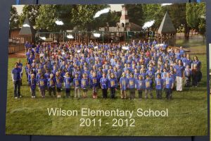 Students and staff in front of a playground