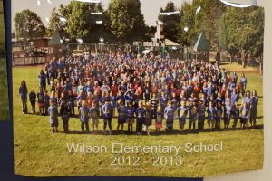 Students and staff in front of a playground