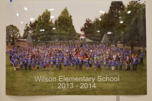 Students and staff in front of a playground