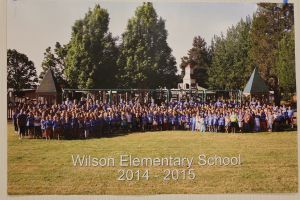 Students and staff in front of a playground