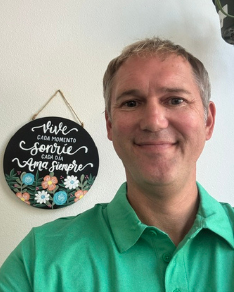 Man in a green shirt, smiling