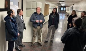 District staff, school board, and district bond oversight committee members stand in the Harding Center