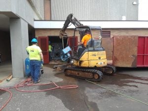 Construction crew removing boiler