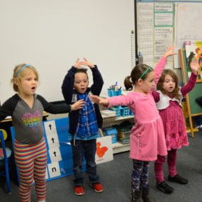 Elementary students standing in classroom