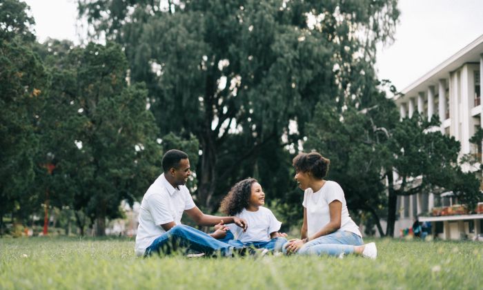 Family sitting on grass